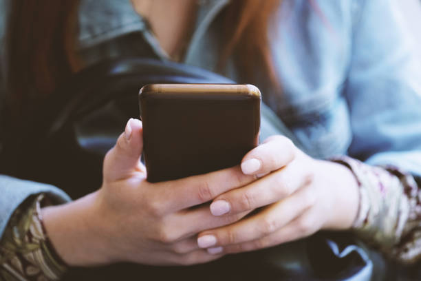 istock Hands of unrecognizable young woman using smartphone or mobile phone 1310254180