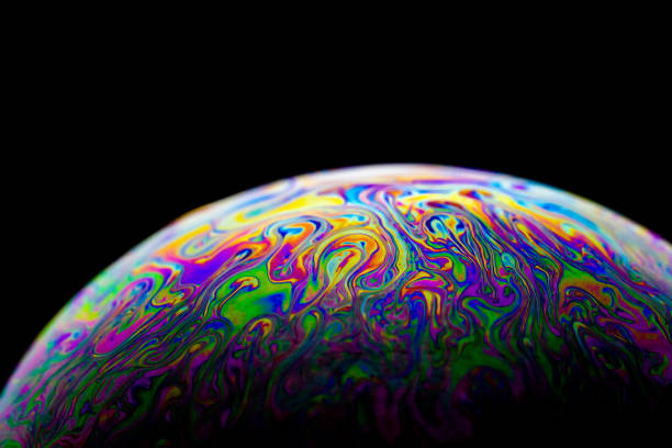 istock Beautiful abstract and various colored soap bubble macro with oval shape with black background and selective focus. 1310254940