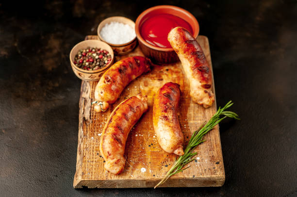 istock grilled sausages with spices and ketchup on a stone table 1310255076