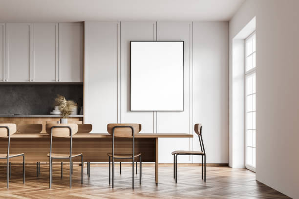 istock Stylish white kitchen interior with poster and table 1310255226