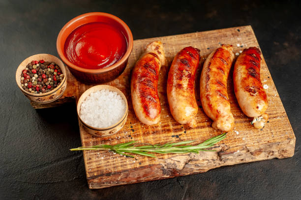 istock grilled sausages with spices and ketchup on a stone table 1310255264