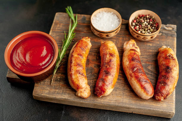 istock grilled sausages with spices and ketchup on a stone table 1310255269