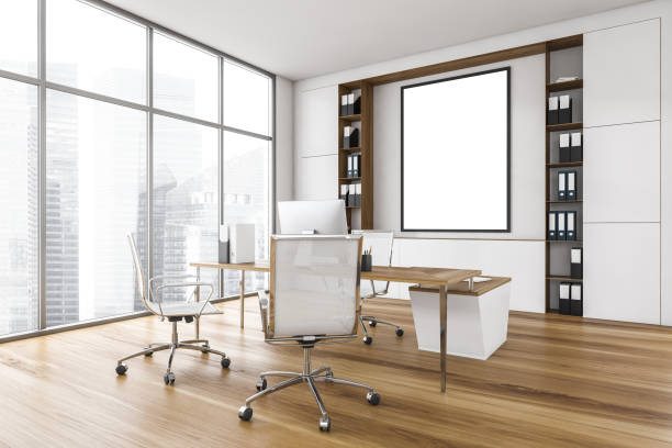 istock Mockup frame in white wooden office room with chairs, table and computer 1310255489