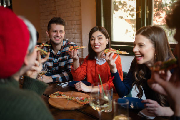 istock Cheerful friends eating pizza in a restaurant 1310255521