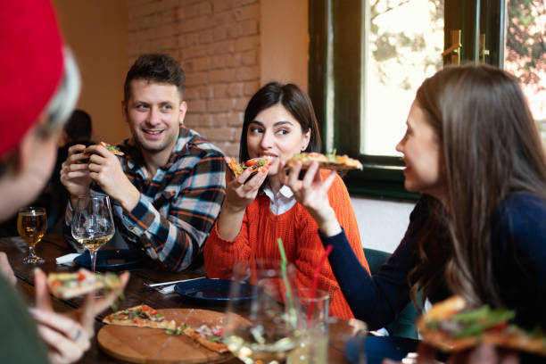 istock Young diverse people eating pizza in a restaurant 1310255528
