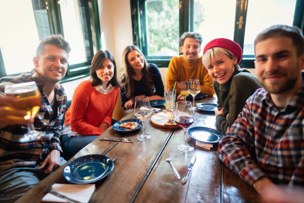 istock Young friends taking selfie with smart phone in a restaurant 1310256099