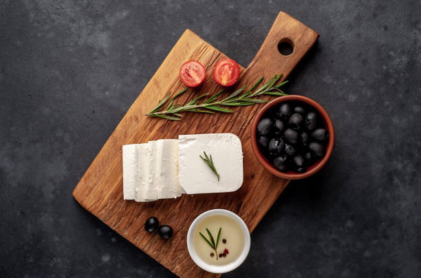 istock feta cheese, with rosemary, tomatoes, olives on a stone background 1310256802