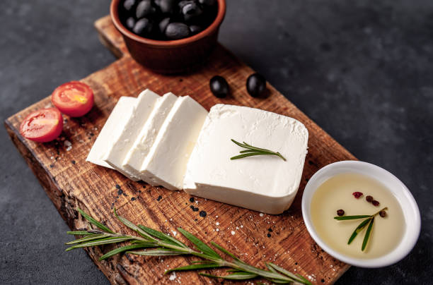istock feta cheese, with rosemary, tomatoes, olives on a stone background 1310256921