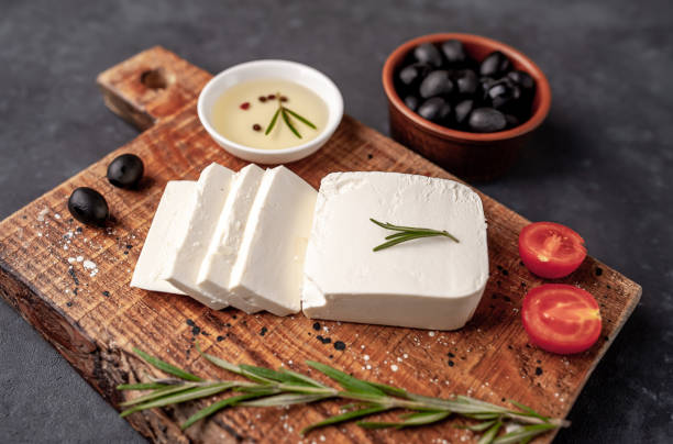 istock feta cheese, with rosemary, tomatoes, olives on a stone background 1310256942