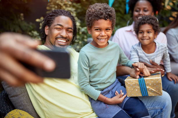 istock Man with family taking selfie together 1310257732