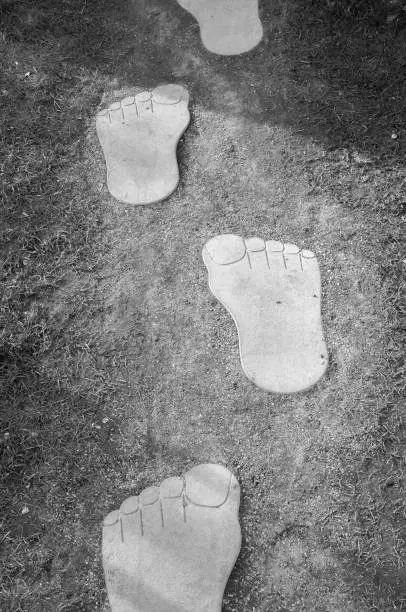 Photo of Close up of giant stone footprint. Image of yetti foot print