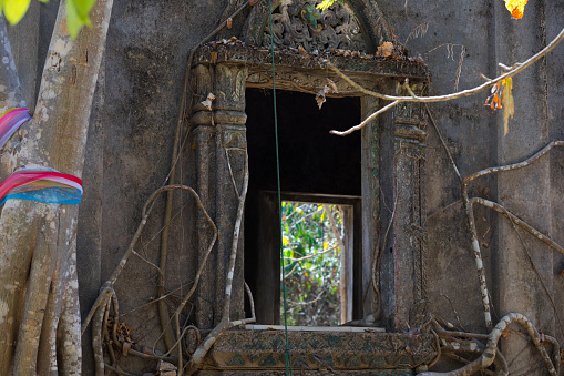 Angkor, Cambodia - December 9, 2012: Tourists are visiting the Baphuon temple in Angkor, Cambodia. Built in the 11th century, the temple has collapsed under the ages. It restoration started in 1960 and after a few attempts has been completed in 2011.