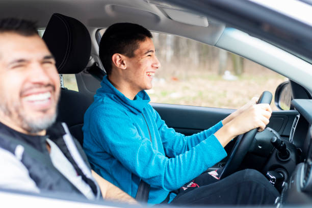 istock Teenage boy having driving lesson with male instructor 1310261520