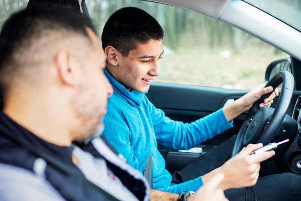 istock Teenage boy having driving lesson with male instructor 1310261526