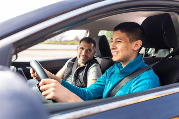 istock Teenage boy having driving lesson with male instructor 1310261542