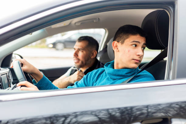 istock Teenage boy having driving lesson with male instructor 1310261559