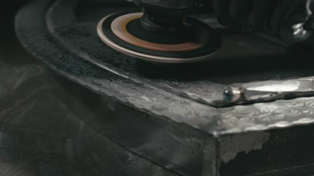 istock Forge workshop. Smithy manual production. Polish metal with an angle grinder with an abrasive nozzle. Polishing iron. 1310262458