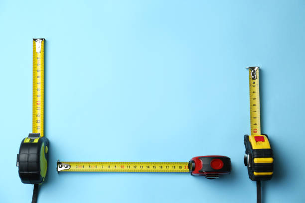 istock Tapes measure on light blue background, flat lay. Space for text 1310263920