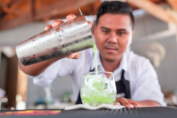 istock Bartender is making cocktail at counter bar. 1310263960