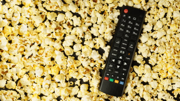 istock Black TV remote control, background with popcorn. Leisure concept. 1310265039