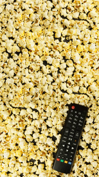 istock Black TV remote control, background with popcorn. Leisure concept. 1310265098