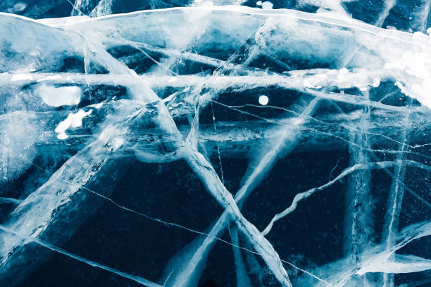 istock Transparent cracked blue ice on Baikal lake in winter. 1310265974