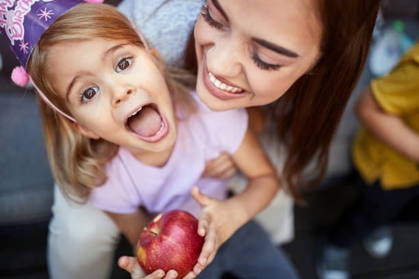 Top view of mother with daughter Top view of mother with daughter with apple birthday wishes for daughter stock pictures, royalty-free photos & images