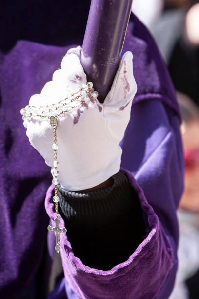 istock Detail penitent white holding a candle during Holy Week, Spain 1310268414