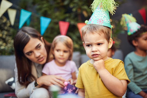 B-day boy celebrates his birthday with children outdoor