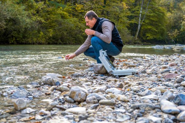 istock Male biologist taking water sample from river 1310268916