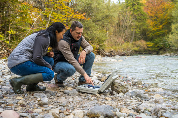 istock Male and female biologists testing the water in river 1310268957