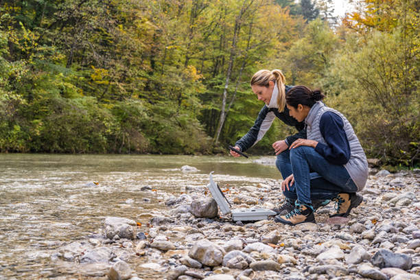 istock Female biologists examining water quality with digital device 1310269615