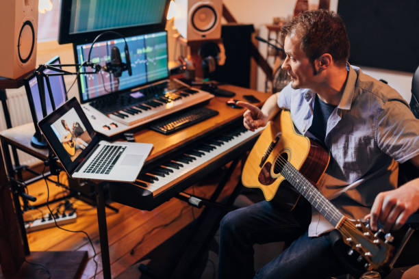 istock While leading his online music class via video call, teacher explaining to his female student, to take care of her rhythm while playing guitar 1310269624