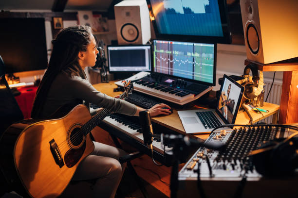 istock Female sound engineer, working from her home record studio, mixing the new jazz song, while her female friend helping her with advices, during video call 1310269625