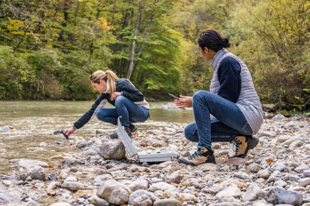 istock Female biologists examining water quality with digital device 1310269915