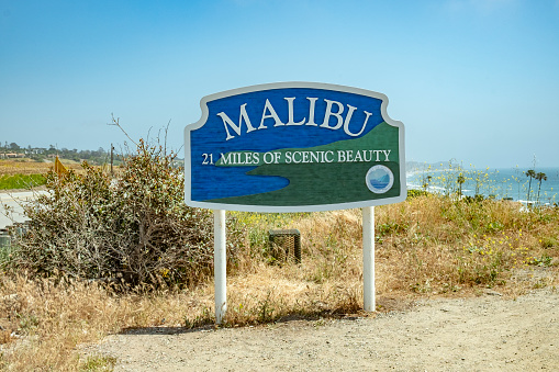 Malibu, USA - April 24, 2019: street signage Malibu 21 Miles of scenic beauty at Highway no 1 at the californian coast, USA.