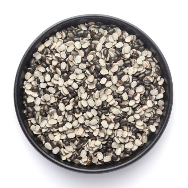 istock Macro Close up of Organic split black urad dal (Vigna mungo) with the shell on a ceramic black bowl. 1310271284
