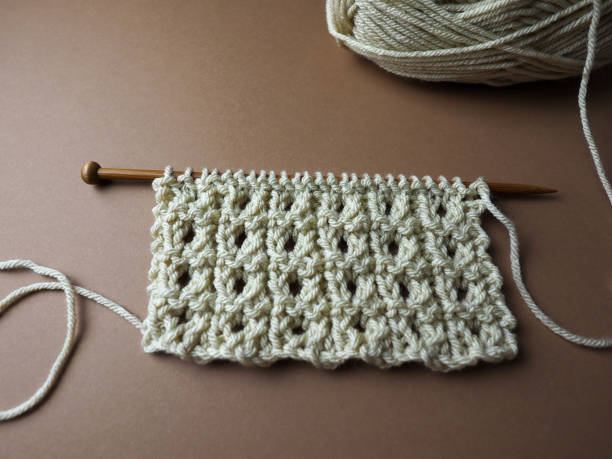 istock Wooden knitting needles with richly textured hand knit fabric 1310271560