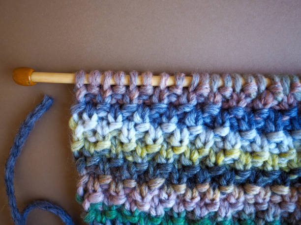 istock Wooden knitting needles with richly textured hand knit fabric 1310271566
