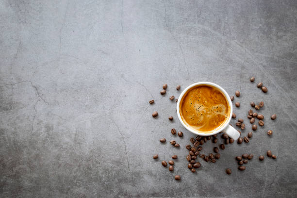 istock hot espresso and coffee beans on old cement floor background. top view. flat lay. space for text 1310274044
