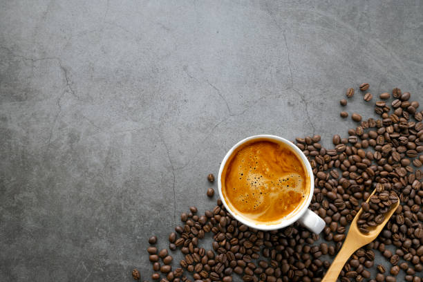 istock hot espresso and coffee beans on old cement floor background. top view. flat lay. space for text 1310274049