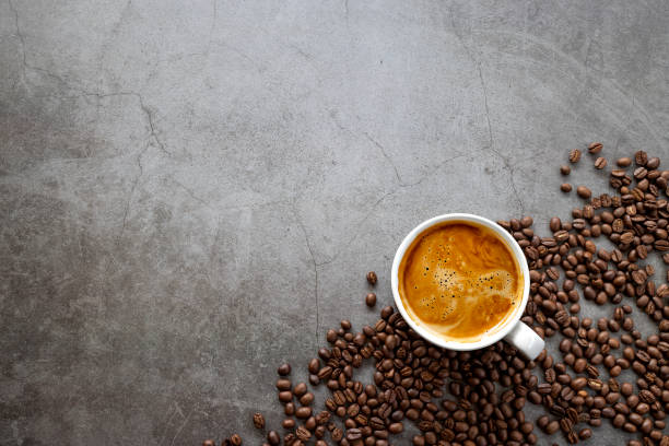 istock hot espresso and coffee beans on old cement floor background. top view. flat lay. space for text 1310274058
