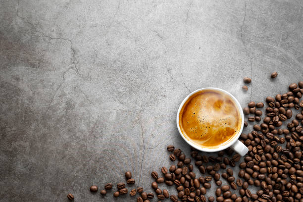 istock hot espresso and coffee beans on old cement floor background. top view. flat lay. space for text 1310274060
