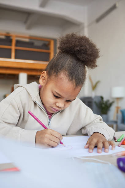 istock Cute African American Girl Drawing 1310274155