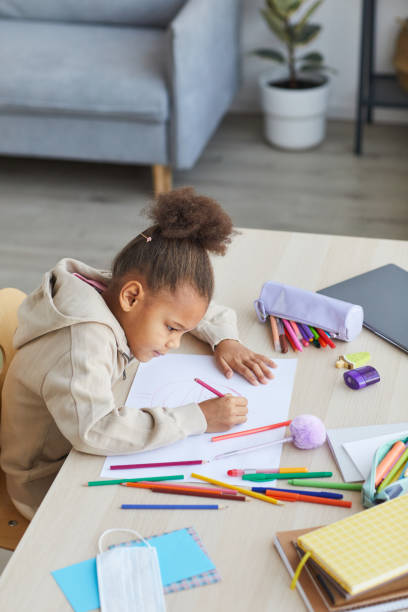 istock African Girl Drawing at Desk 1310274178