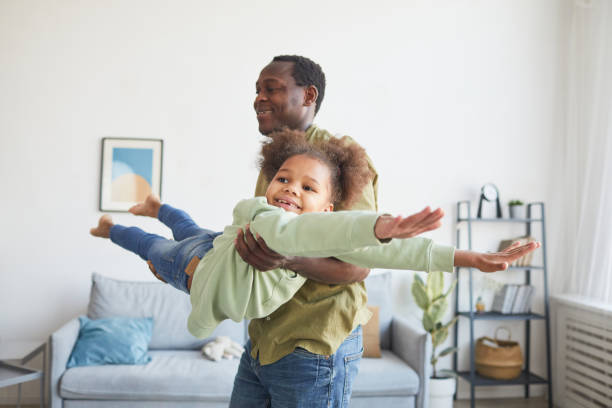 istock Girl Playing Airplane with Dad 1310274241