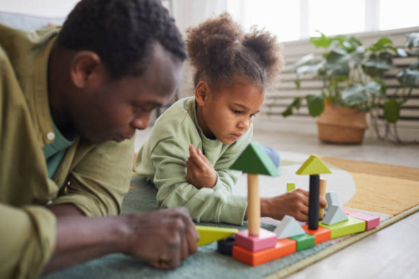 istock Father Playing with Daughter on Floor 1310274260