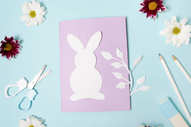 istock DIY ideas instruction for making Easter Card. handmade card on blue background with flowers 1310274610