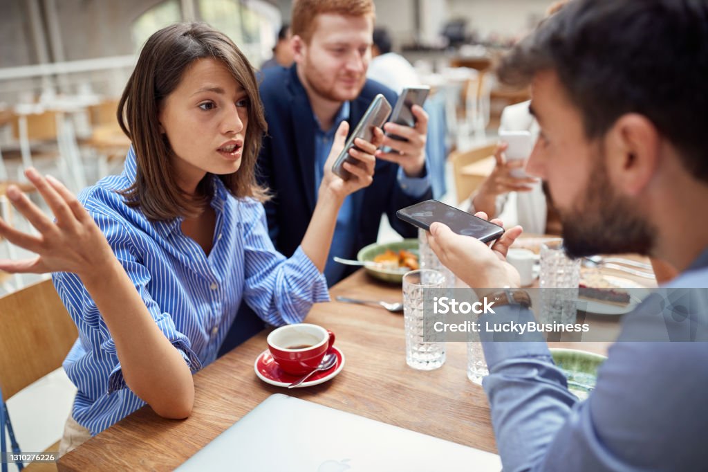 young businesswoman helplessly spreading hands, explaining, defending herself about bad business after corona virus. young businesswoman helplessly spreading hands, explaining, defending herself about bad business after corona virus. economy after covid 19 Arguing Stock Photo