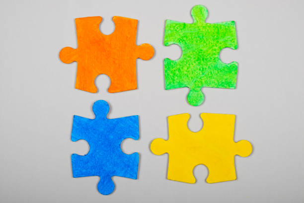 istock autism symbol, different colored puzzles on a white background 1310279051